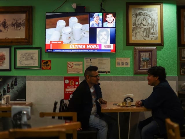 patrons talk and drink next to a tv showing the news of the arrest of mexican drug lord ismael el mayo zambada and the son of his former partner joaquin el chapo guzman at a private airport in el paso texas at a cantina in mexico city mexico july 25 2024 photo reuters